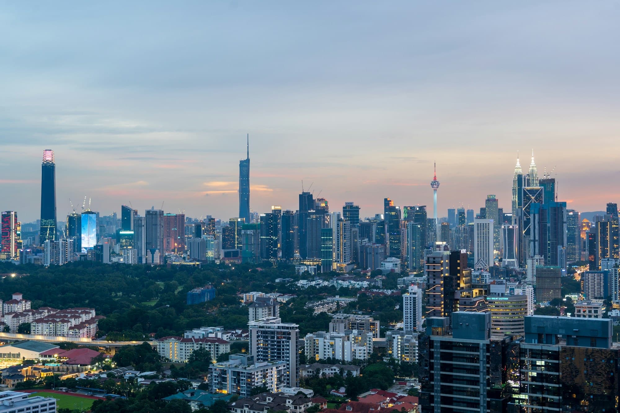 Kuala Lumpur skyline at sunset with the Petronas Twin Towers and KL Tower
