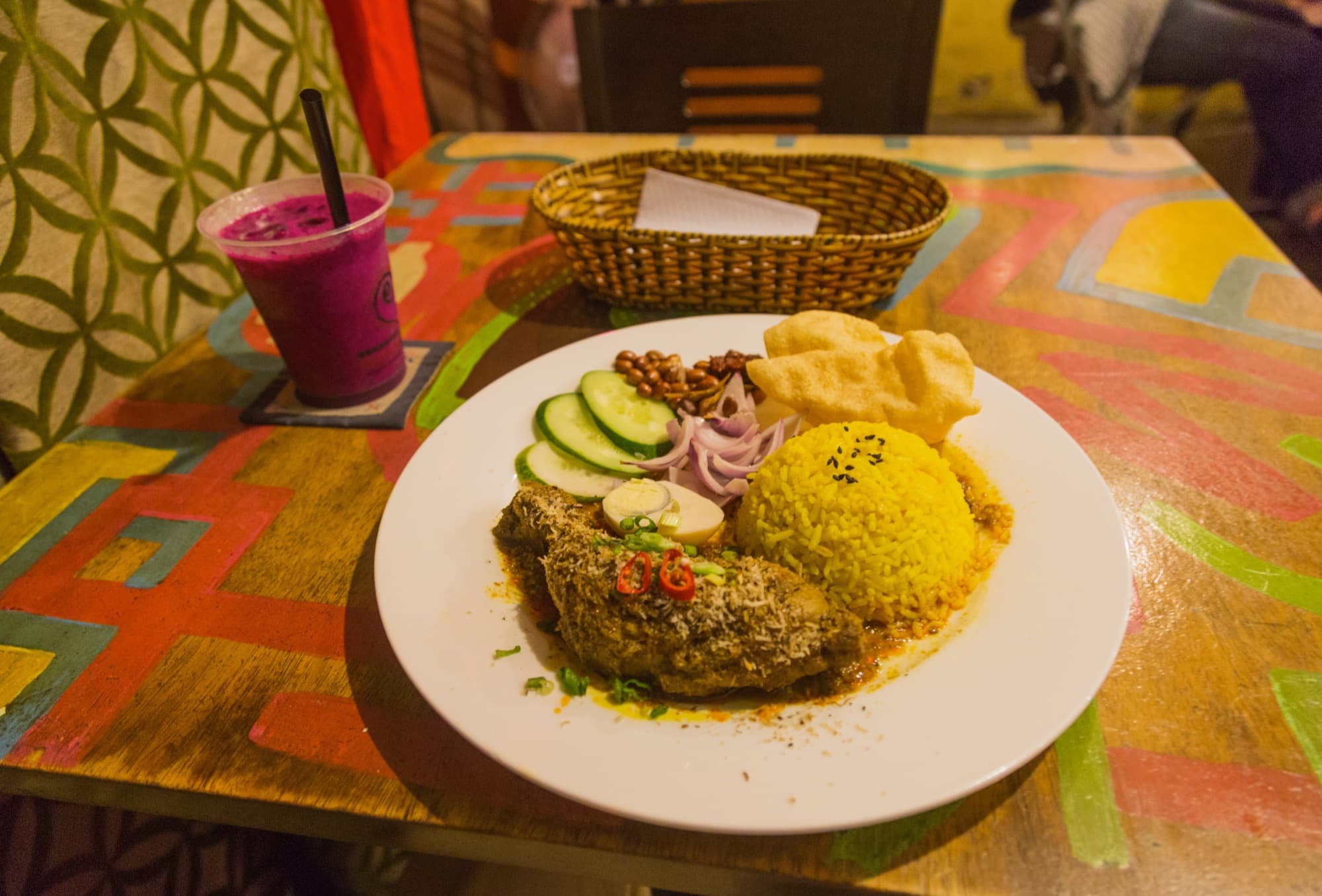 A Malaysian nasi lemak plate with coconut rice, sambal, egg, anchovies and peanuts
