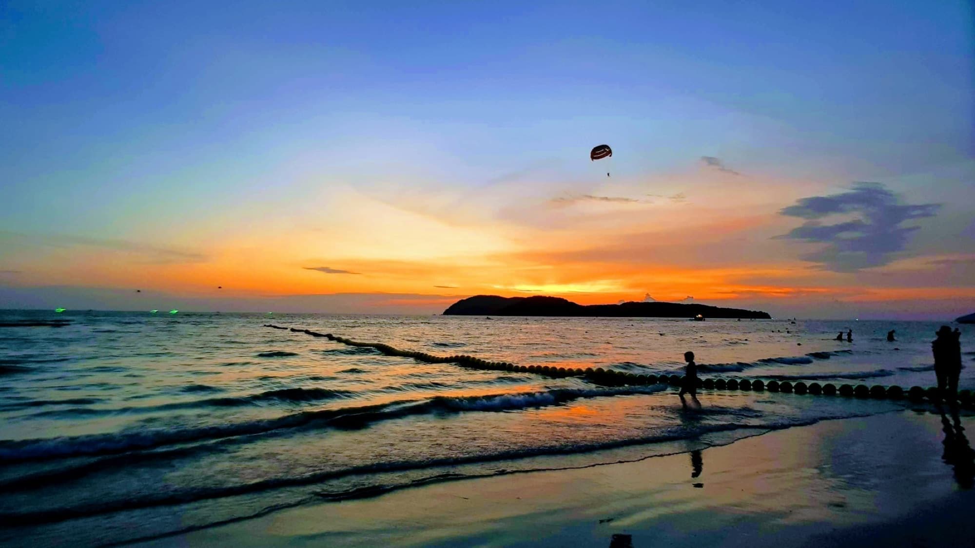 People enjoying sunset at Pantai Cenang in Langkawi