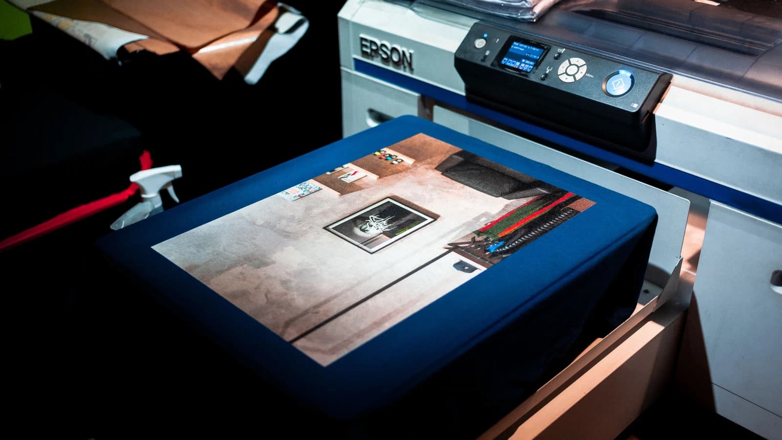 A digital garment printer applying a full-colour image to fabric on a flat platen