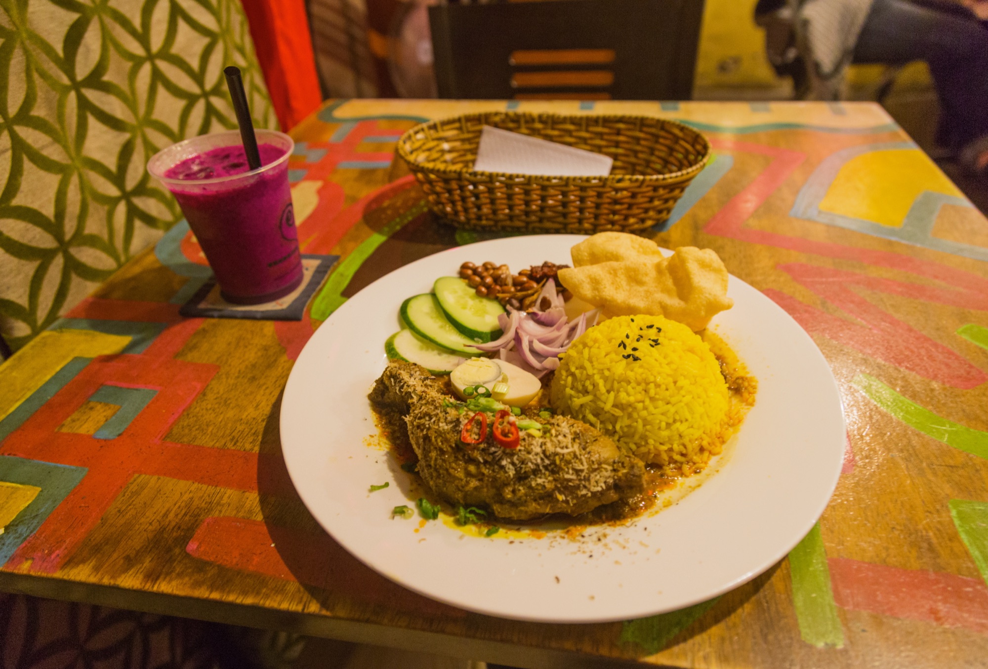 A Malaysian nasi lemak plate with coconut rice, sambal, egg, anchovies and peanuts
