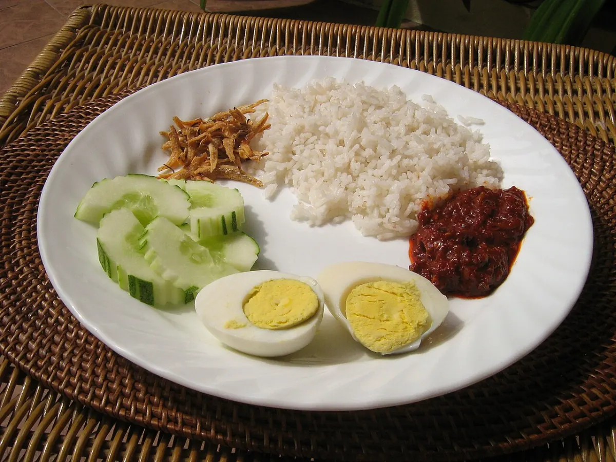Classic nasi lemak with coconut rice, sambal, egg, cucumber and anchovies